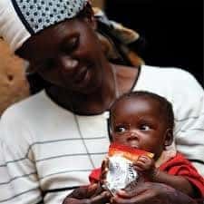 Hungry baby eats peanut butter