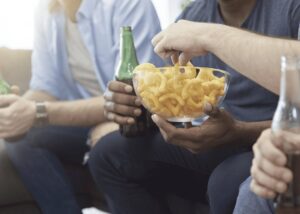 Men Eating Chips And Soda